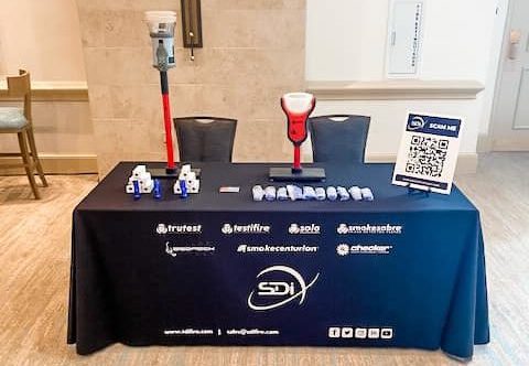 SDi exhibit table displaying a SDi table cloth, testifire, solo 365 and giveaways at the edwards strategic partner conference