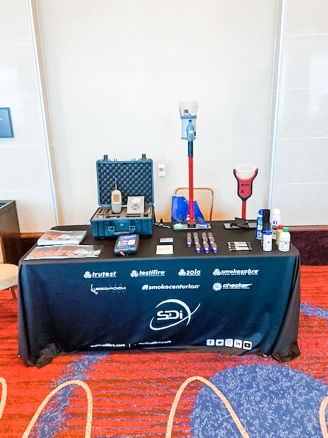 view of SDi's exhibit table at the NJELSA Training Summit. The table displayed product guide, equiptment and giveaways